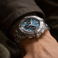 ab0147101c1a1-avenger-chronograph-b01-44-blue-metal-wrist-shot-ecom.png